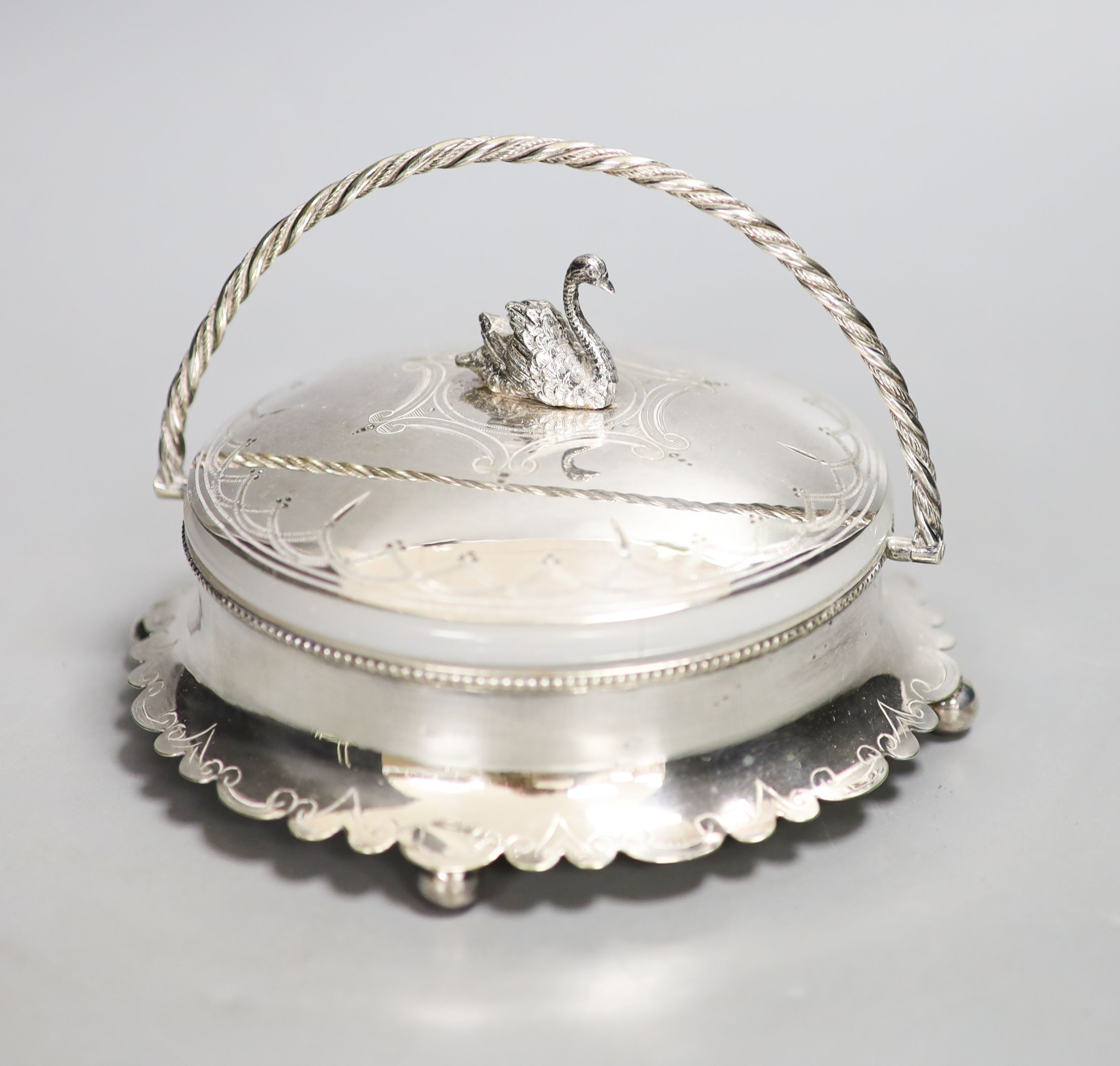 A silver plated powder box, the lid with swan finial.